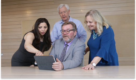 PPRC Employees looking at ipad together