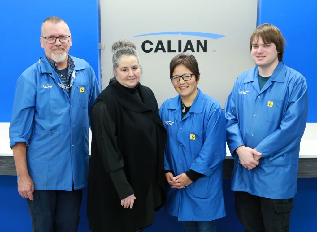The inclusive Team from Calian and PPRC Inc. Four people posing for a picture in front of the Calian logo.